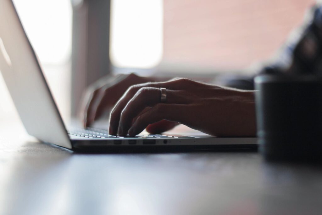 stock photo of a person typing on a laptop