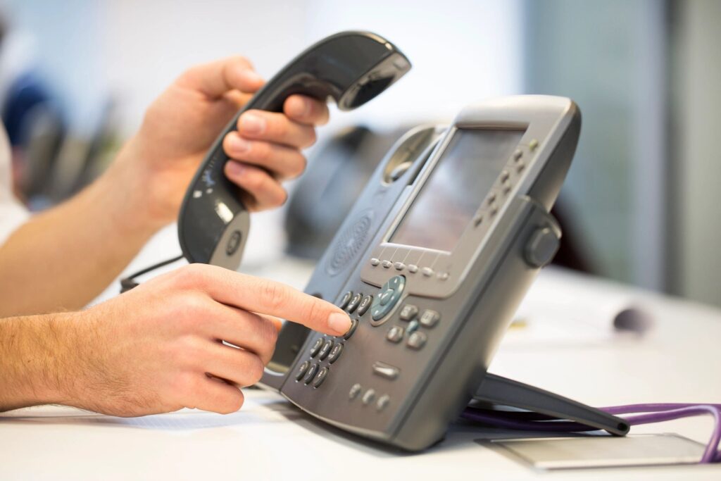 stock photo of a person dialing on a phone